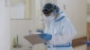 Armenia -- A healthcare worker wearing protective gear takes notes at the Surb Grigor Lusavorich Medical Center, Yerevan, June 5, 2020.