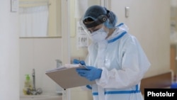 Armenia -- A healthcare worker wearing protective gear takes notes at the Surb Grigor Lusavorich Medical Center, Yerevan, June 5, 2020.