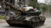 Ілюстраційне фото. Російські солдати на танку в місті Попасна на Луганщині з побутовими речами, які, за словами вимушеної переселенки, були викрадені з її будинку. Попасна, травень 2022 року